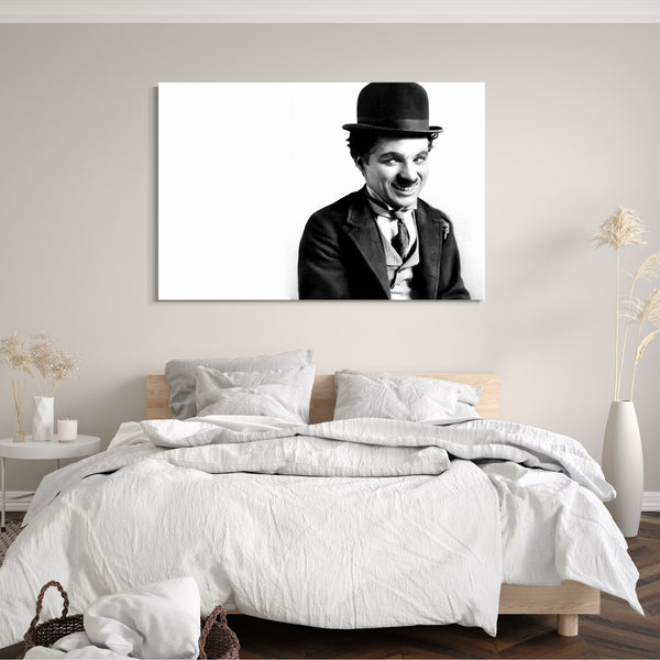 Leinwandbild Charlie Chaplin schelmisch lachend vor weißem Hintergrund