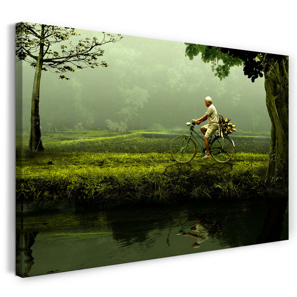 Leinwandbild Mann mit Fahrrad in grünem Regenwald und Fluss mit Spiegelung