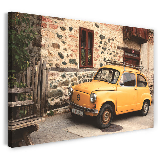 Leinwandbild Autobilder Oldtimer gelb vor Dorf-Kulisse