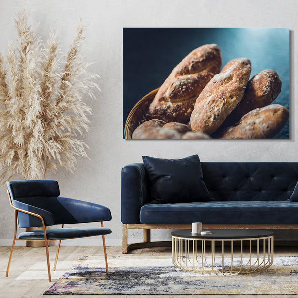 Leinwandbild Essensbilder Brotlaib 6 Stück in Korb vor blauem Hintergrund