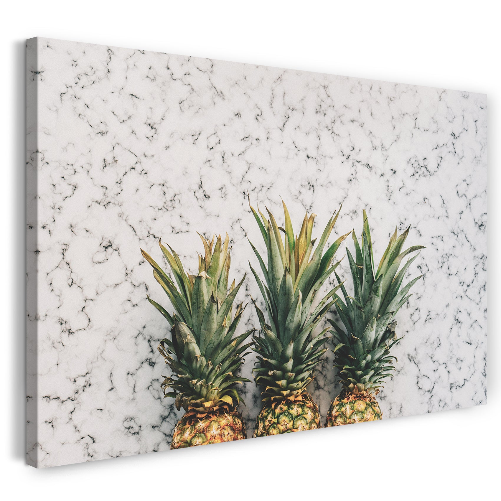 Leinwandbild Essensbilder Früchte drei Ananas auf Marmor-ähnlichem Hintergrund
