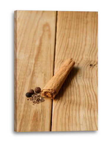 Leinwandbild Wandbild Küchendeko kleine Zimtstange Nahaufnahme hellter Holztisch