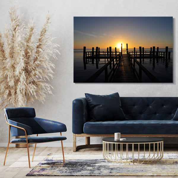 Leinwandbild Holzsteg im Meer unter aufgehender Sonne