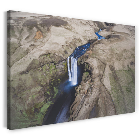 Leinwandbild Wasserfall navy-blau in Felsenlandschaft fotografiert aus der Luft