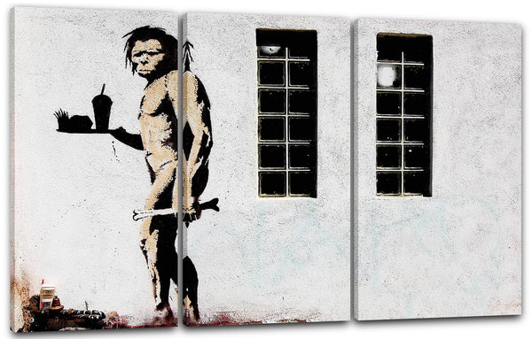 Leinwandbild Banksy - Neandertaler mit Knochen und McDonalds Menü Street Art Graffiti